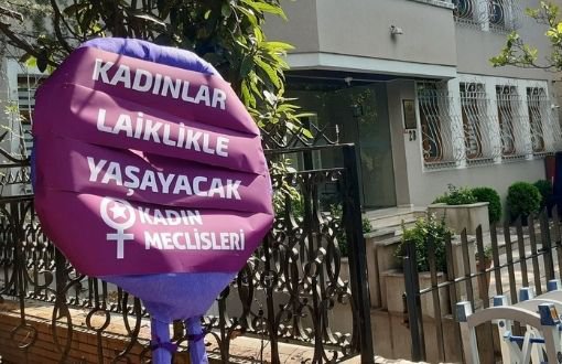Women leave purple wreath in front of Consulate of Afghanistan